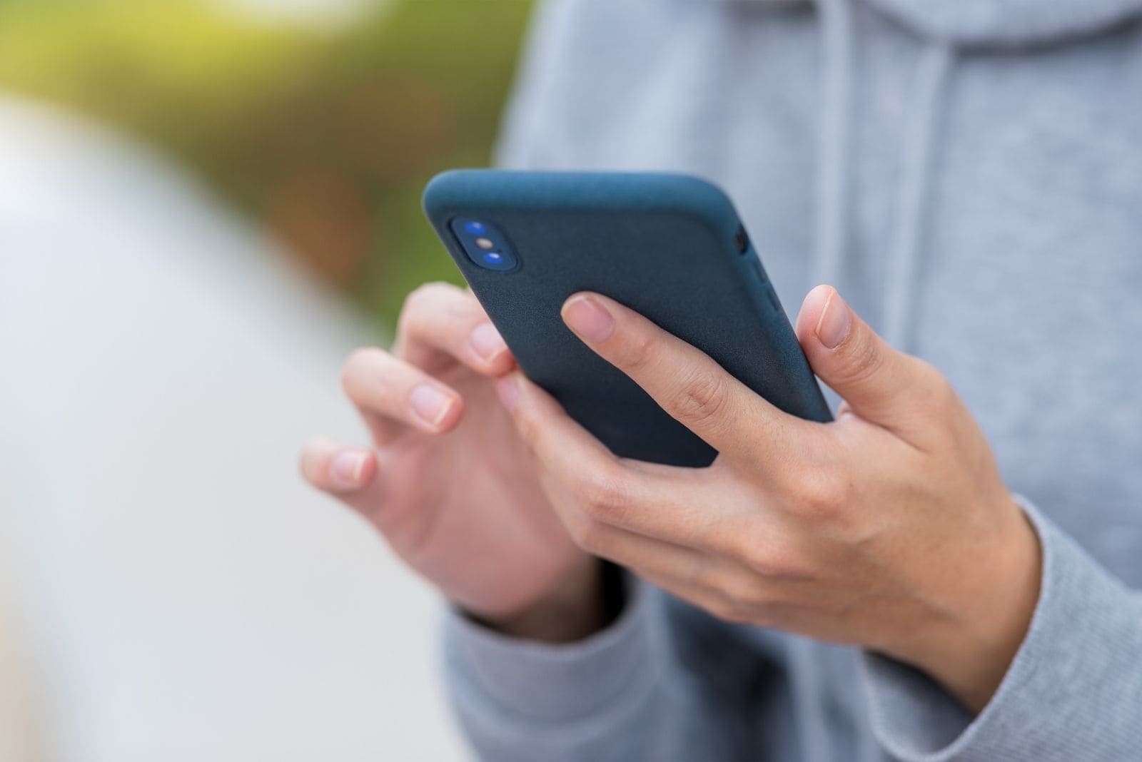 hand part of woman holding a smartphone and browsing