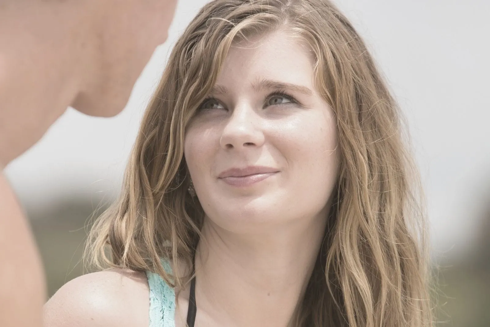 happy young couple looking at each other's eyes at the beach