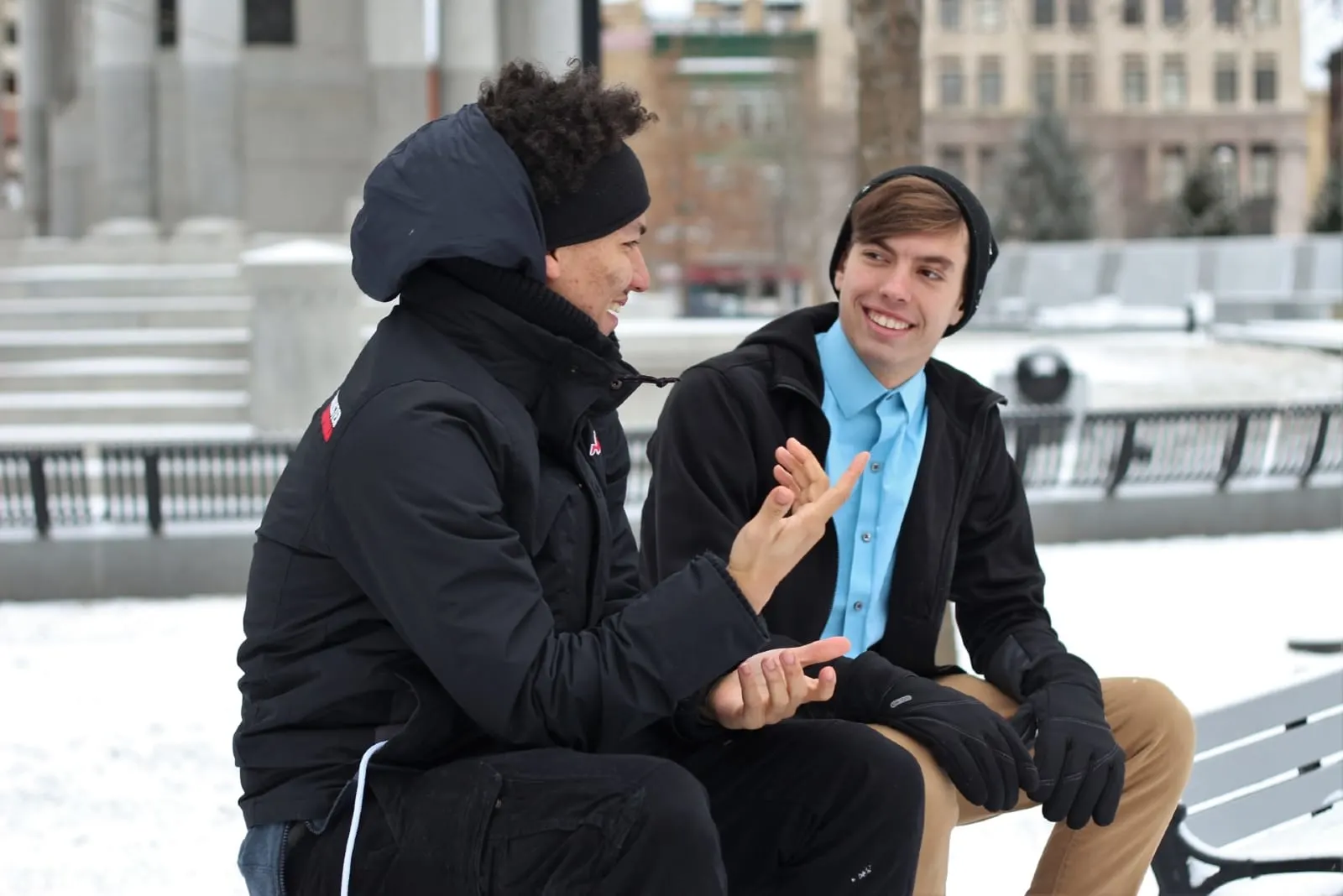 two men talking while sitting outdoor in winter