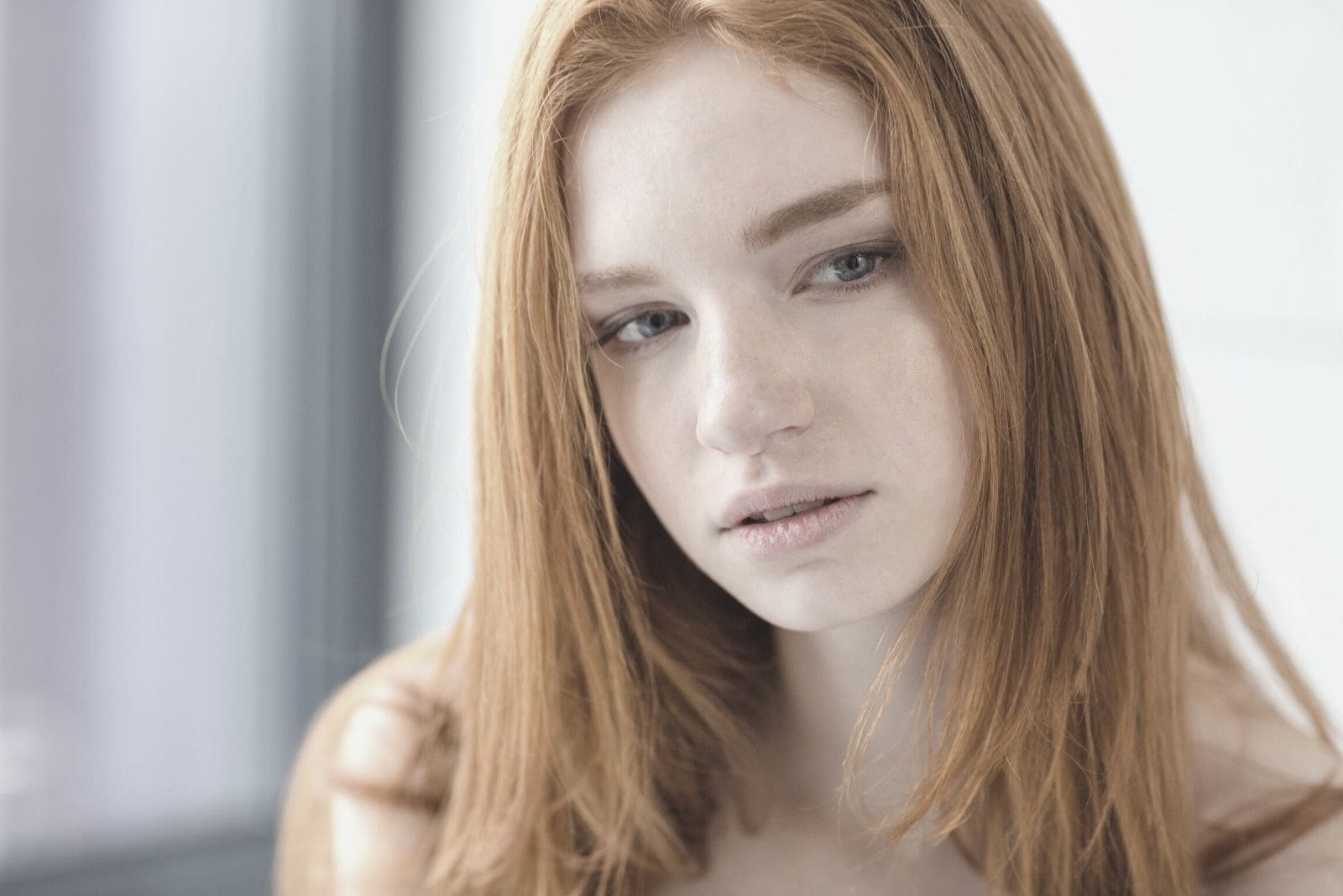 pensive redhead woman looking away in closeup portrait