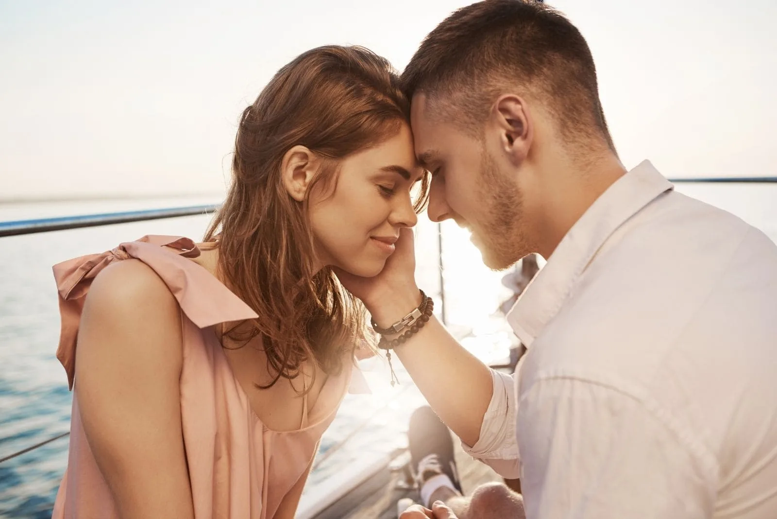 romantic sweet couple in a yatch boat sailing during a sunny day