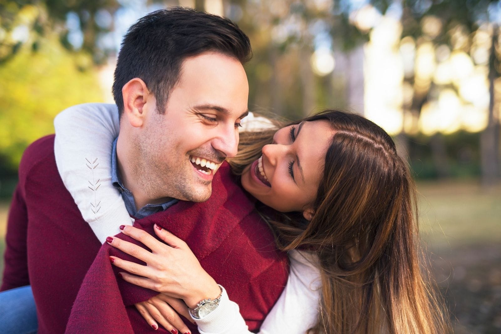 sweet couple hugging and having fun together outdoors