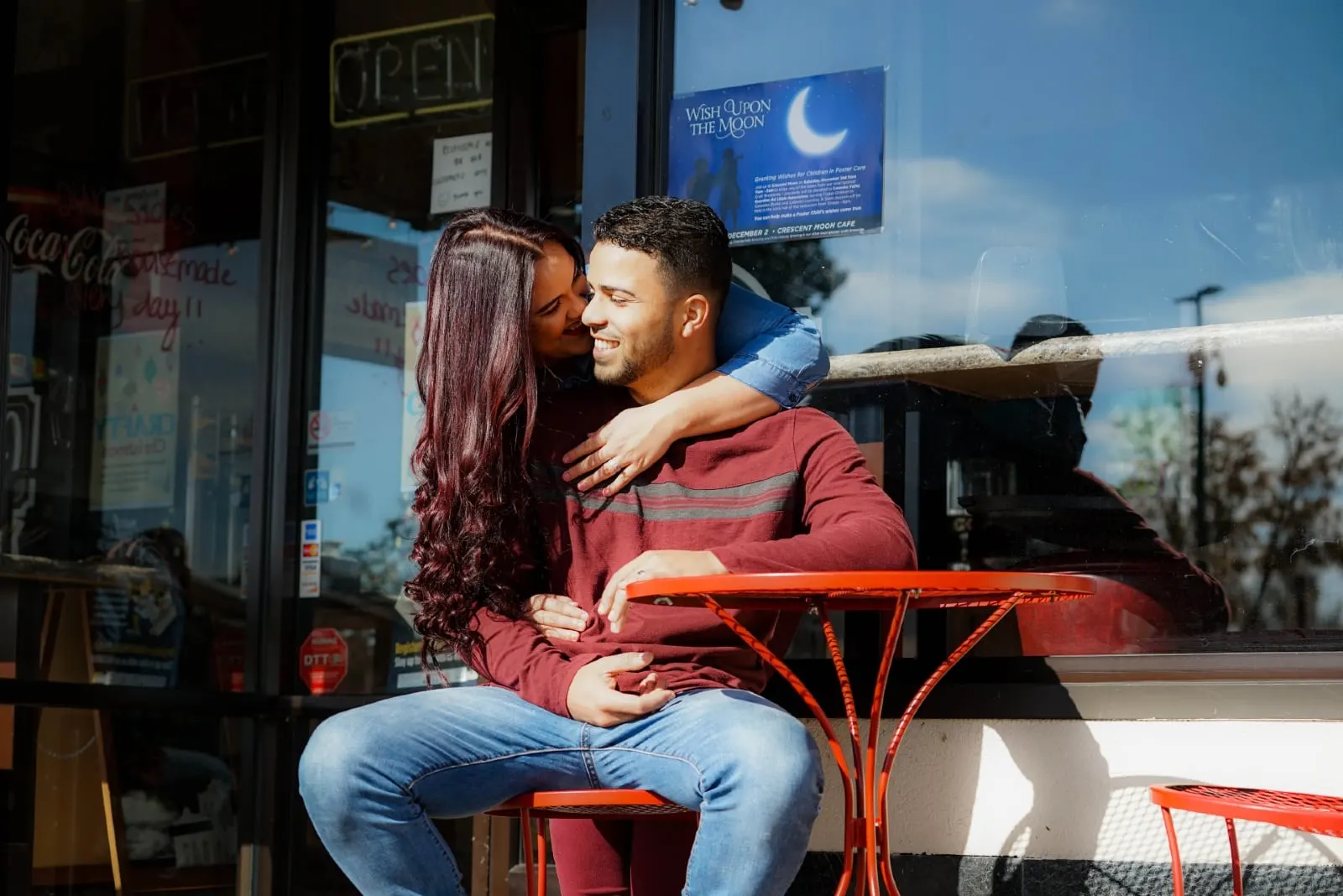 woman kissing man's cheek while standing outdoor