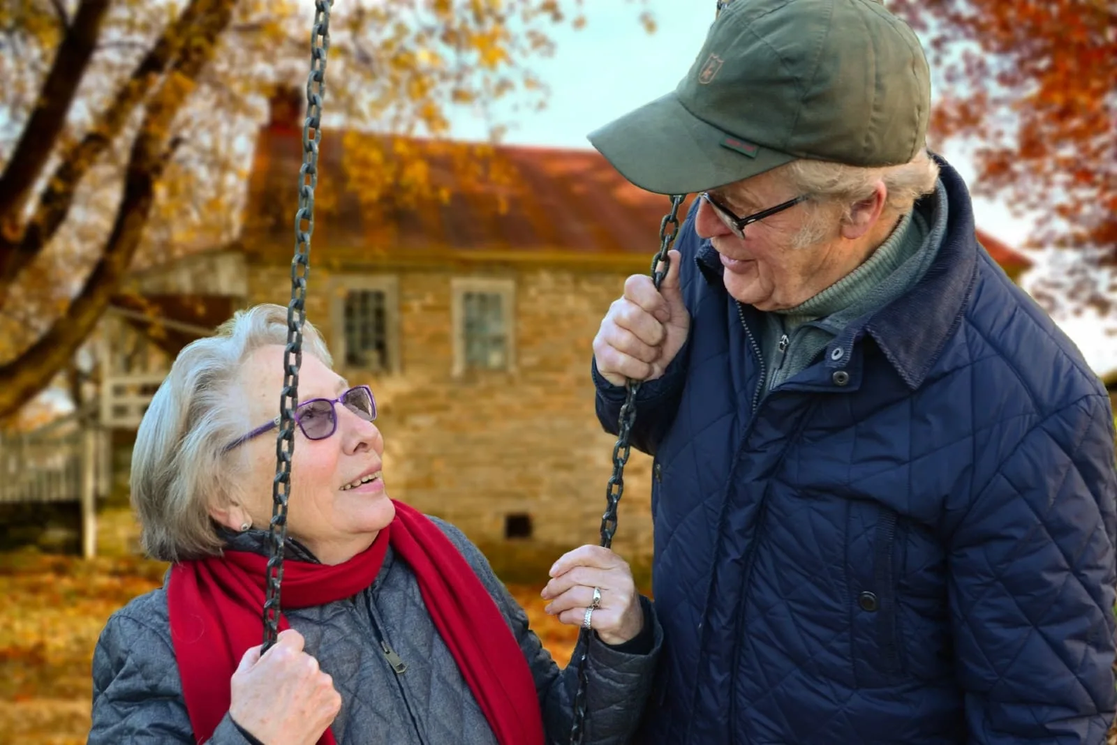 woman looking at man while sitting on swing