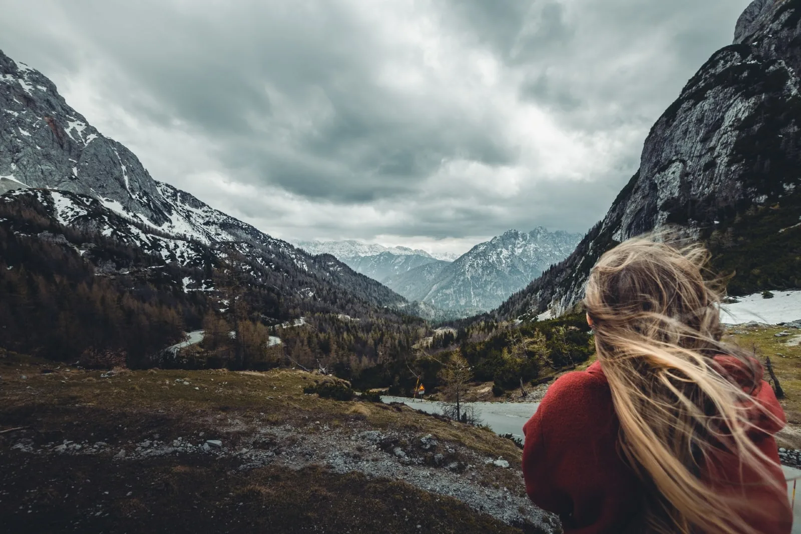 woman in red hoodie looking at mountain