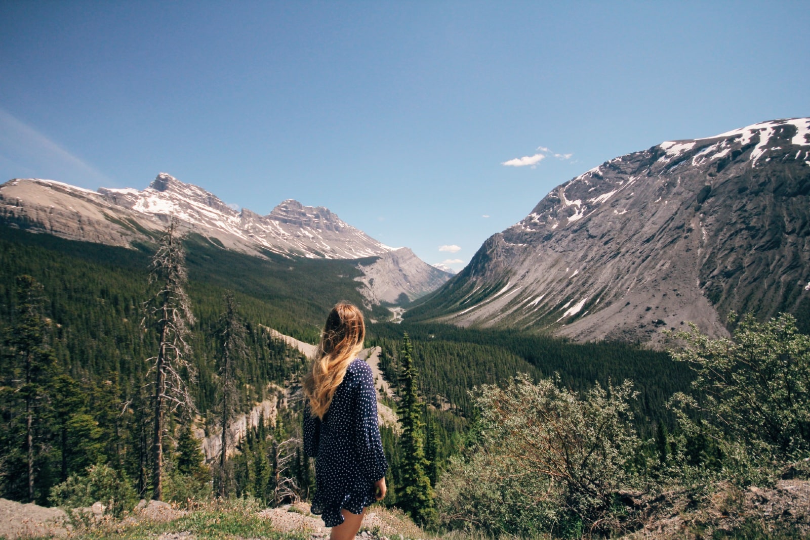 woman in blue polka dot dress looking at mountain
