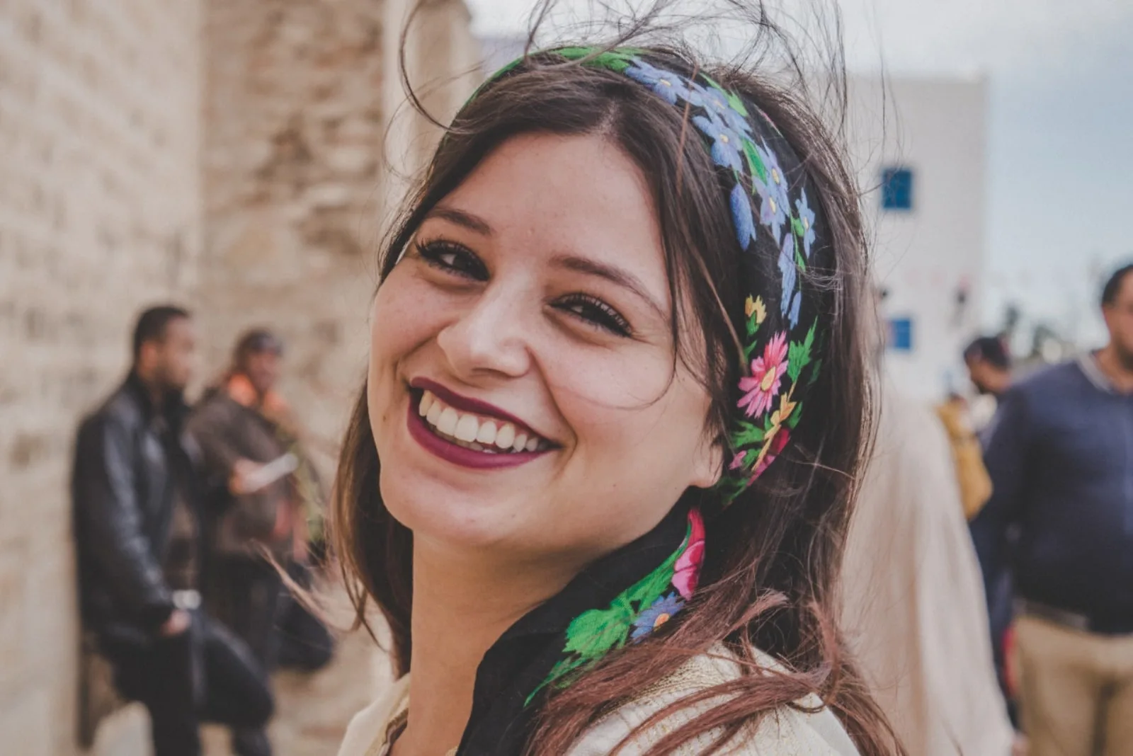 woman with colorful head scarf smiling