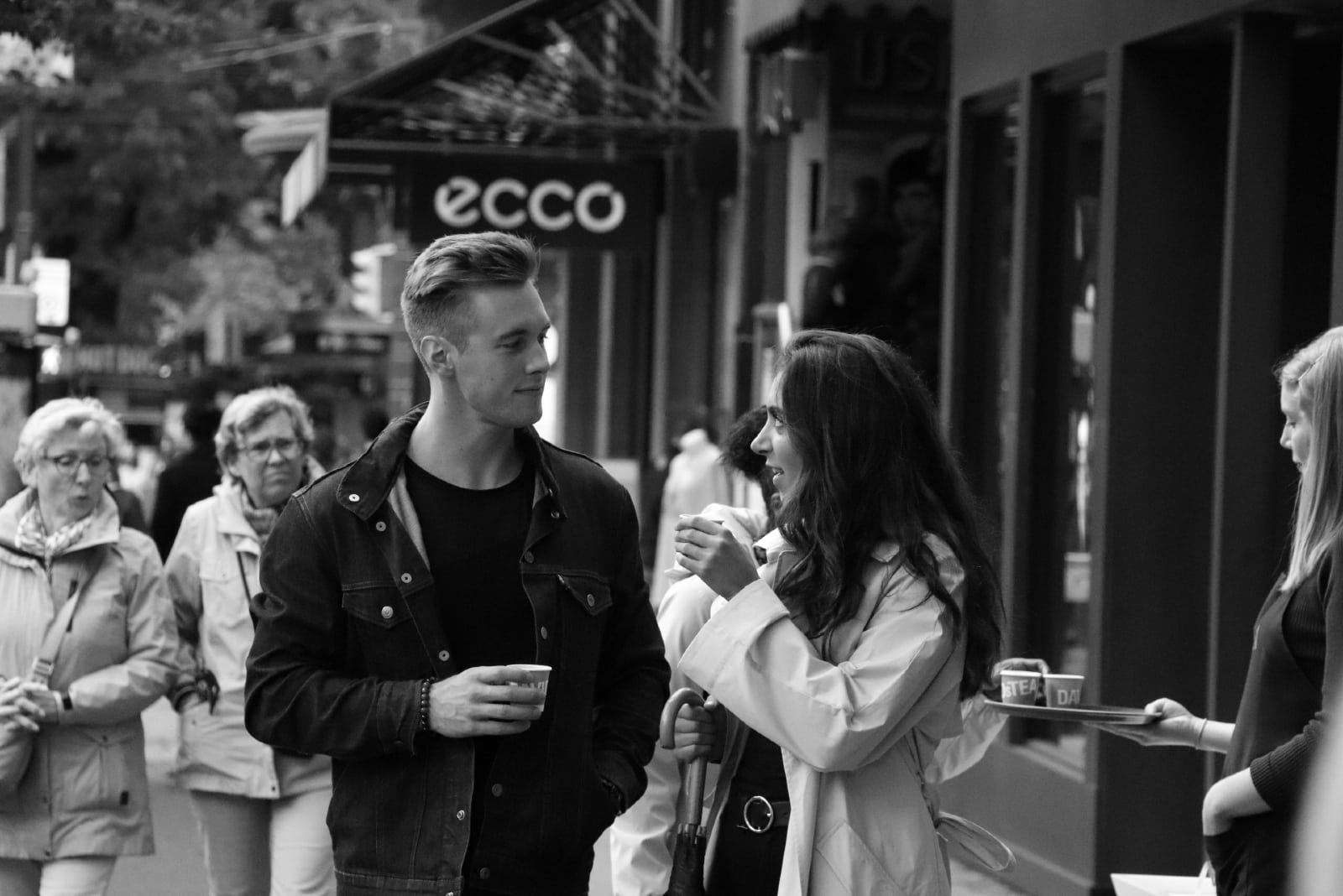 woman talking to man while standing outdoor