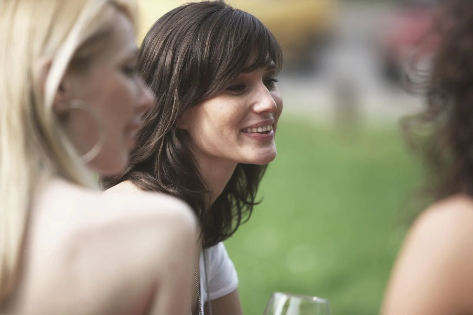 woman with friends enjoying drinking and chatting