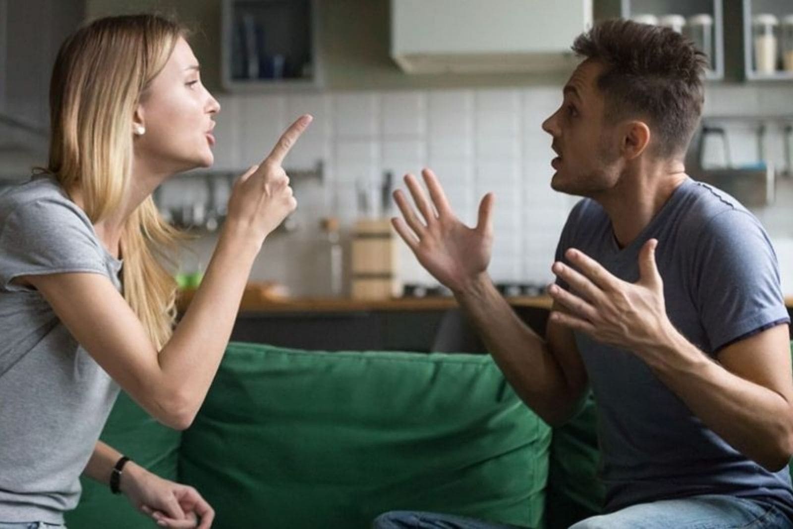 young couple arguing in the livingroom shouting at each other