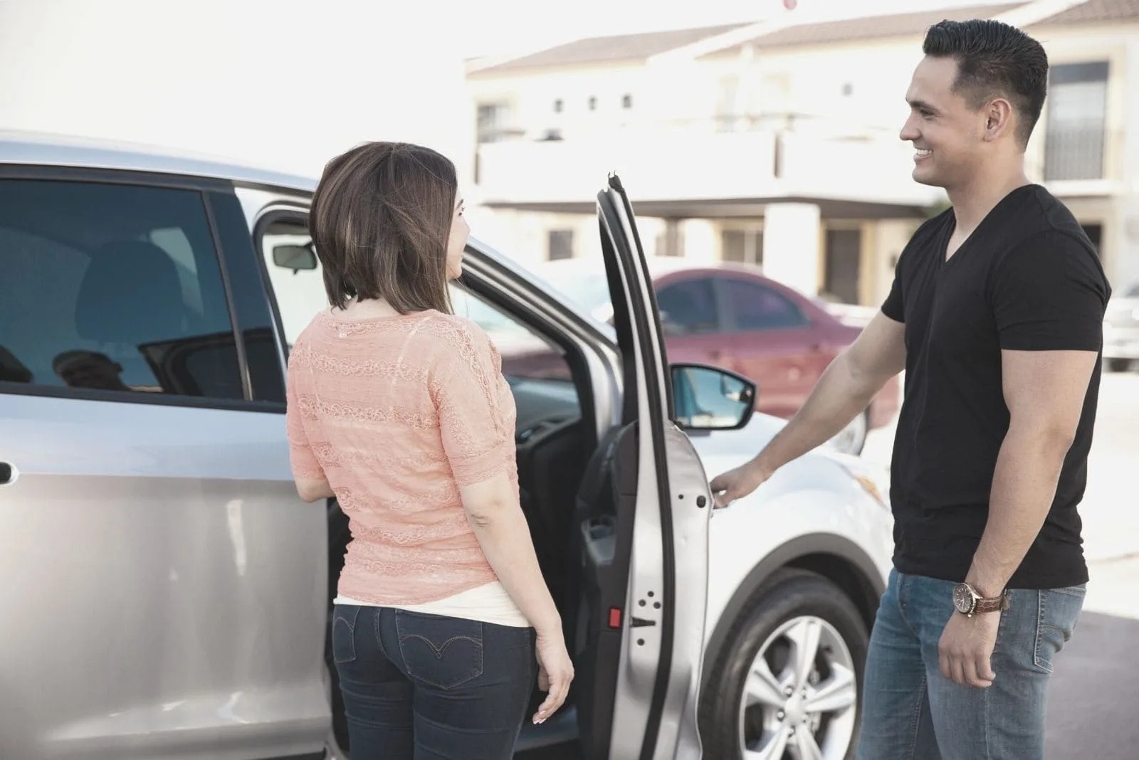 young man opening door of the car for a woman