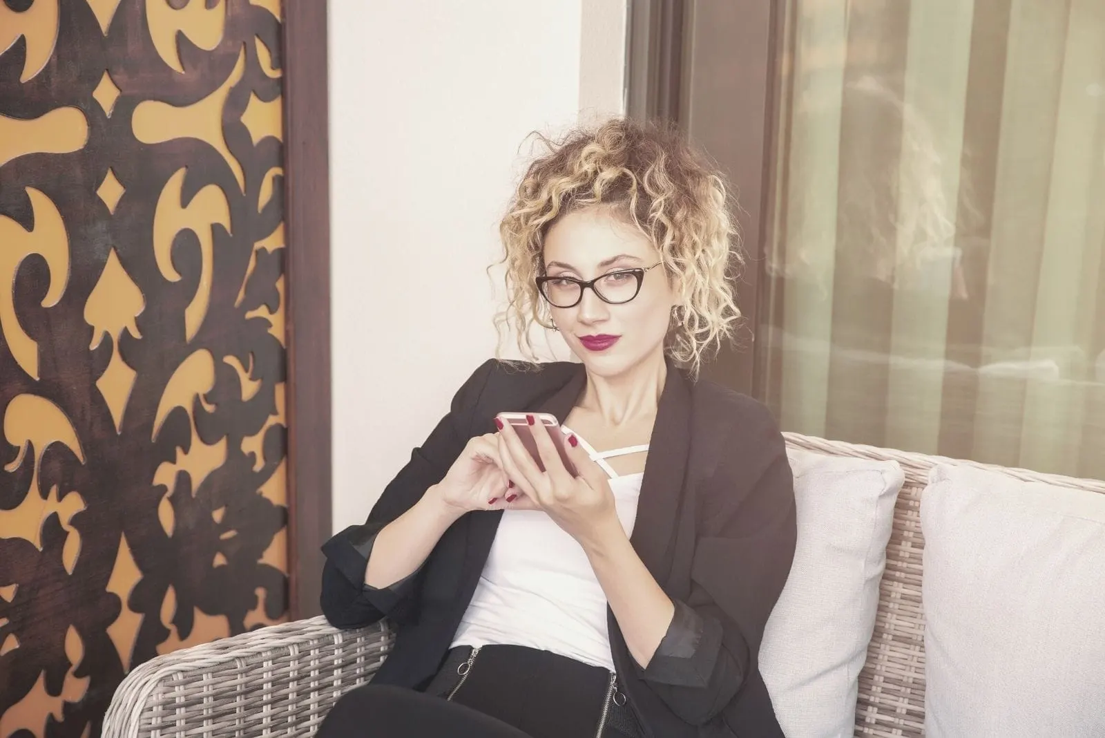 businesswoman social media concept of a woman with a phone and sitting indoors