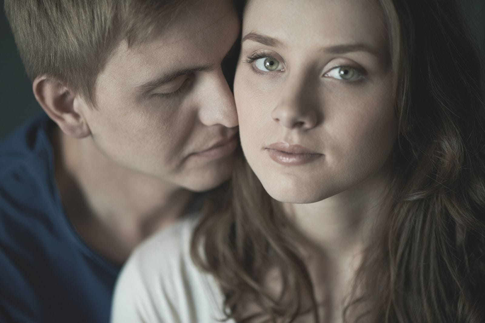 calm woman looking at the camera with her sweetheart nearby