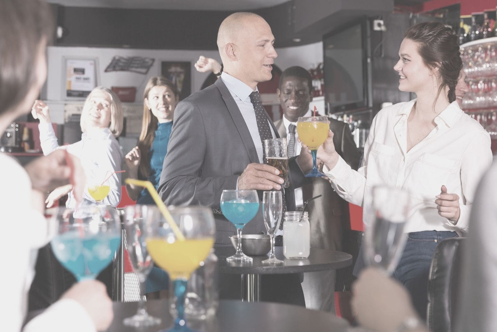 corporate man talking to a woman in a party in a club