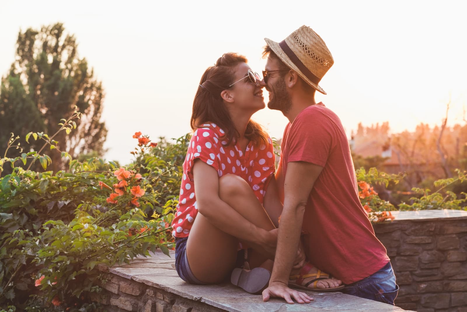 man and woman about to kiss on balcony