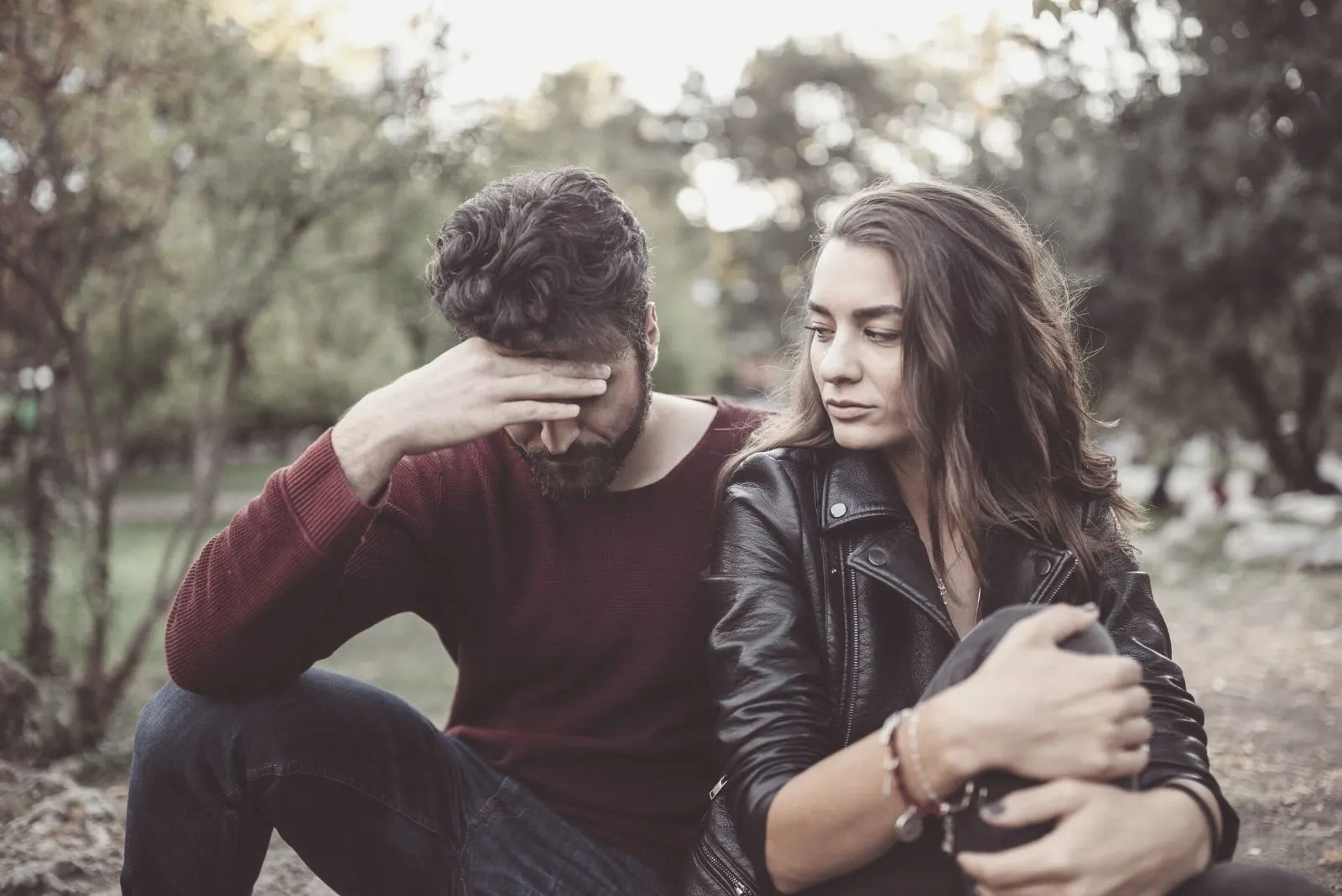 couple breaking up in the park feeling upset