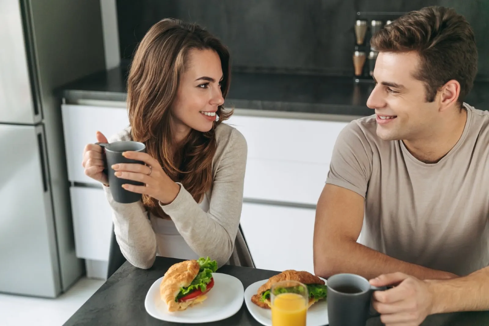 man and woman having breakfast at home