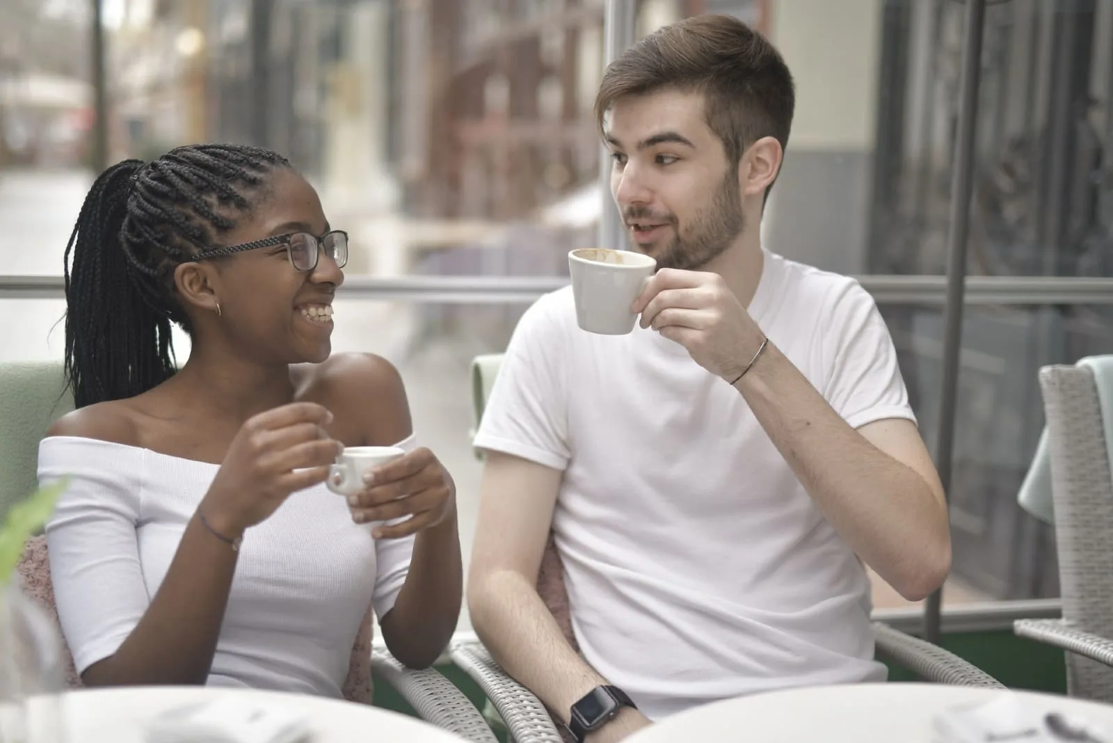 man and woman having coffee in cafe