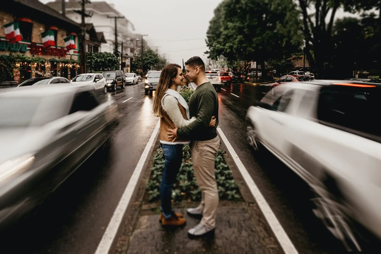 man and woman making eye contact while standing near road