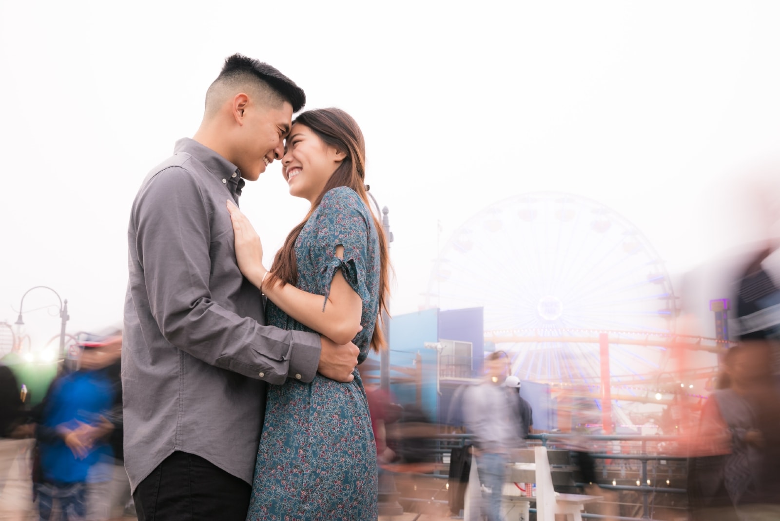 man and woman hugging while standing on the street