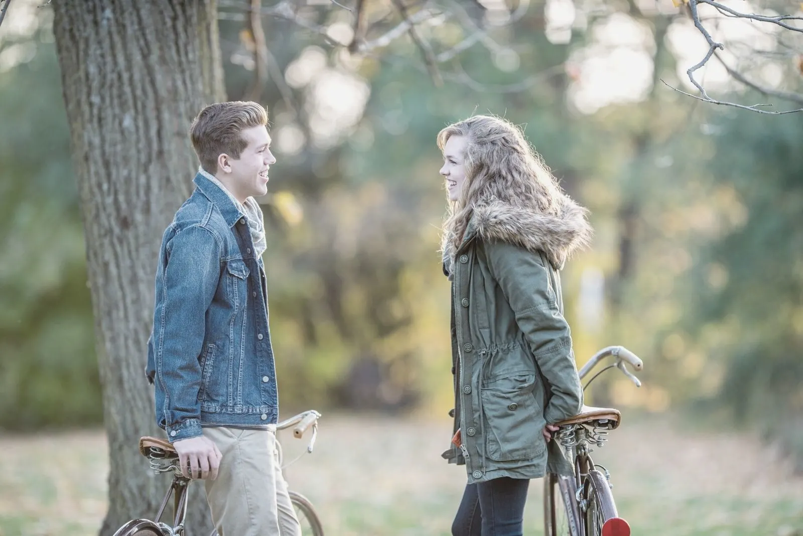 couple talking outdoors dating and biking in the autumn park