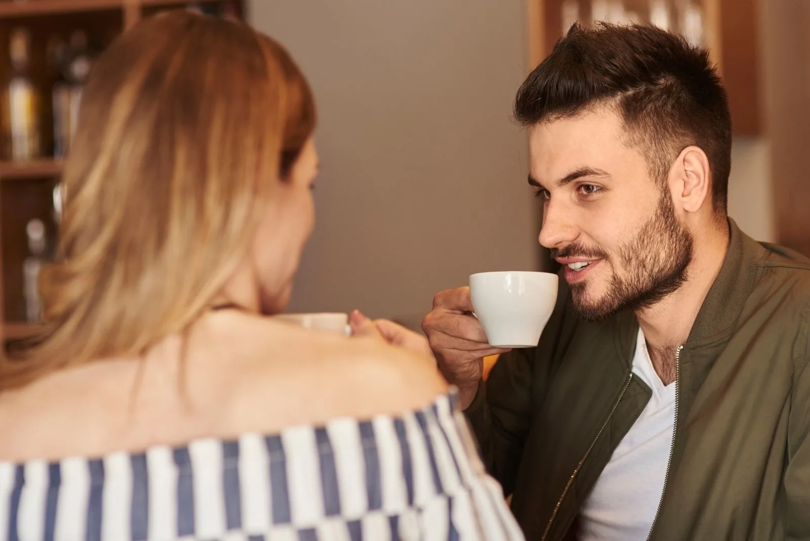 dating couple enjoying coffee and chatting indoors