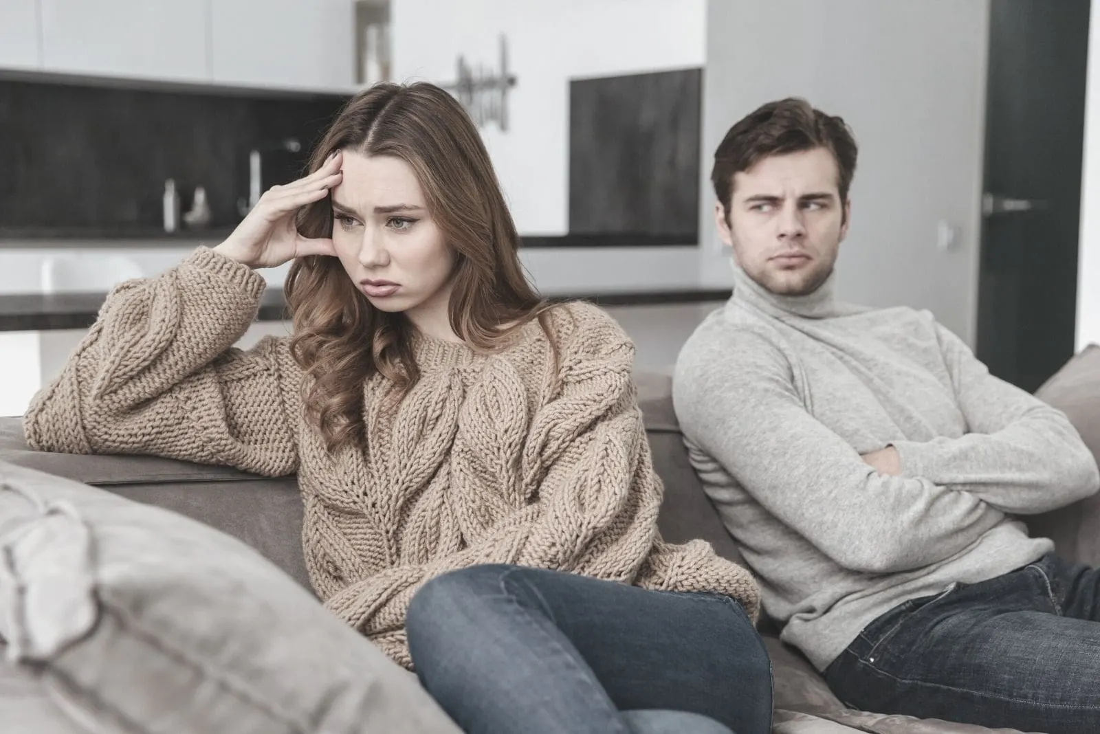 displeased loving couple sitting and not talking to each other