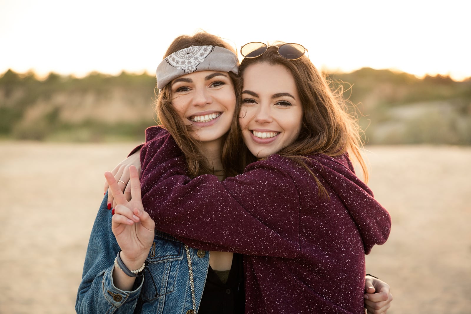 girls hugging each other in the field