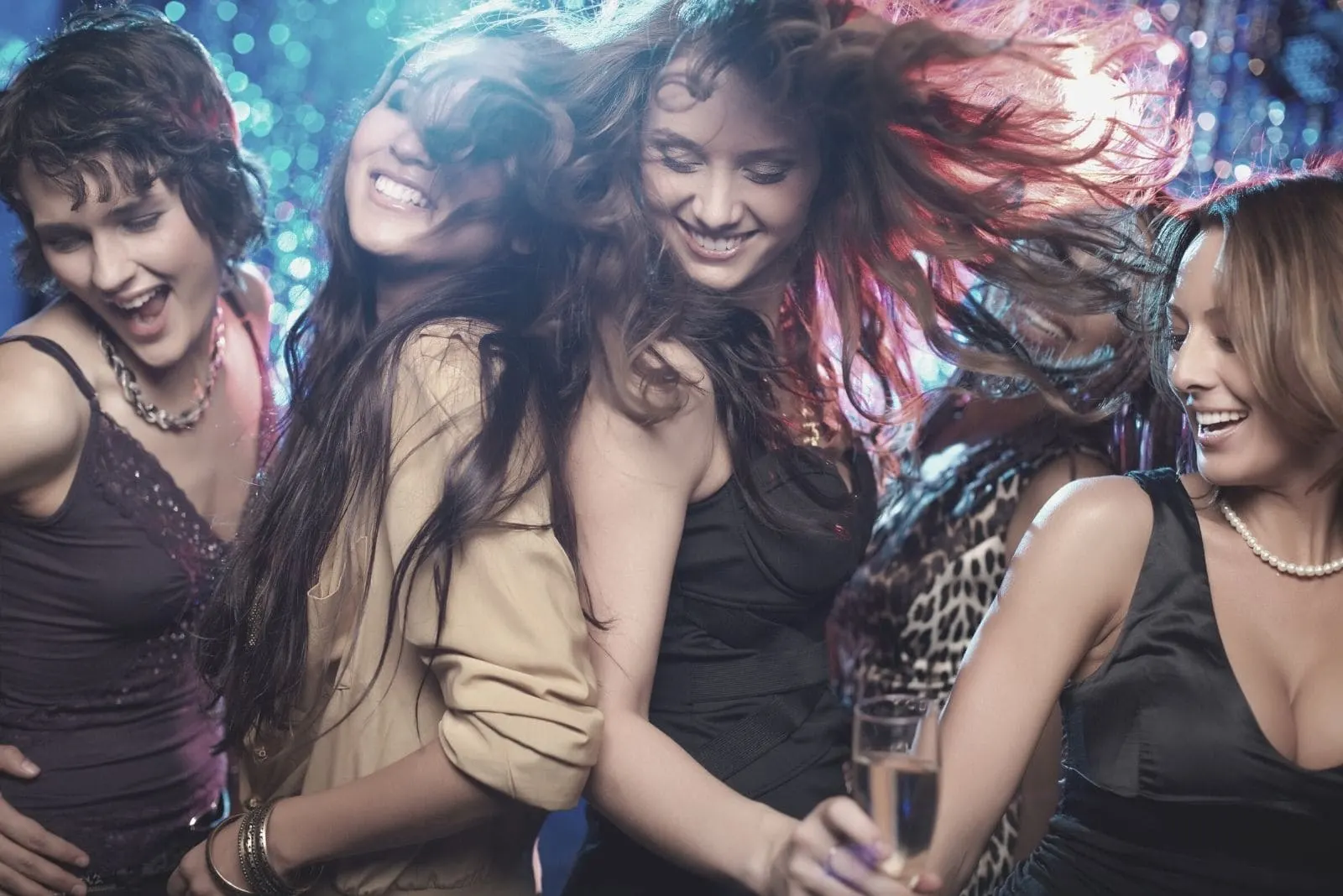 group of female friends dancing and enjoying in the club