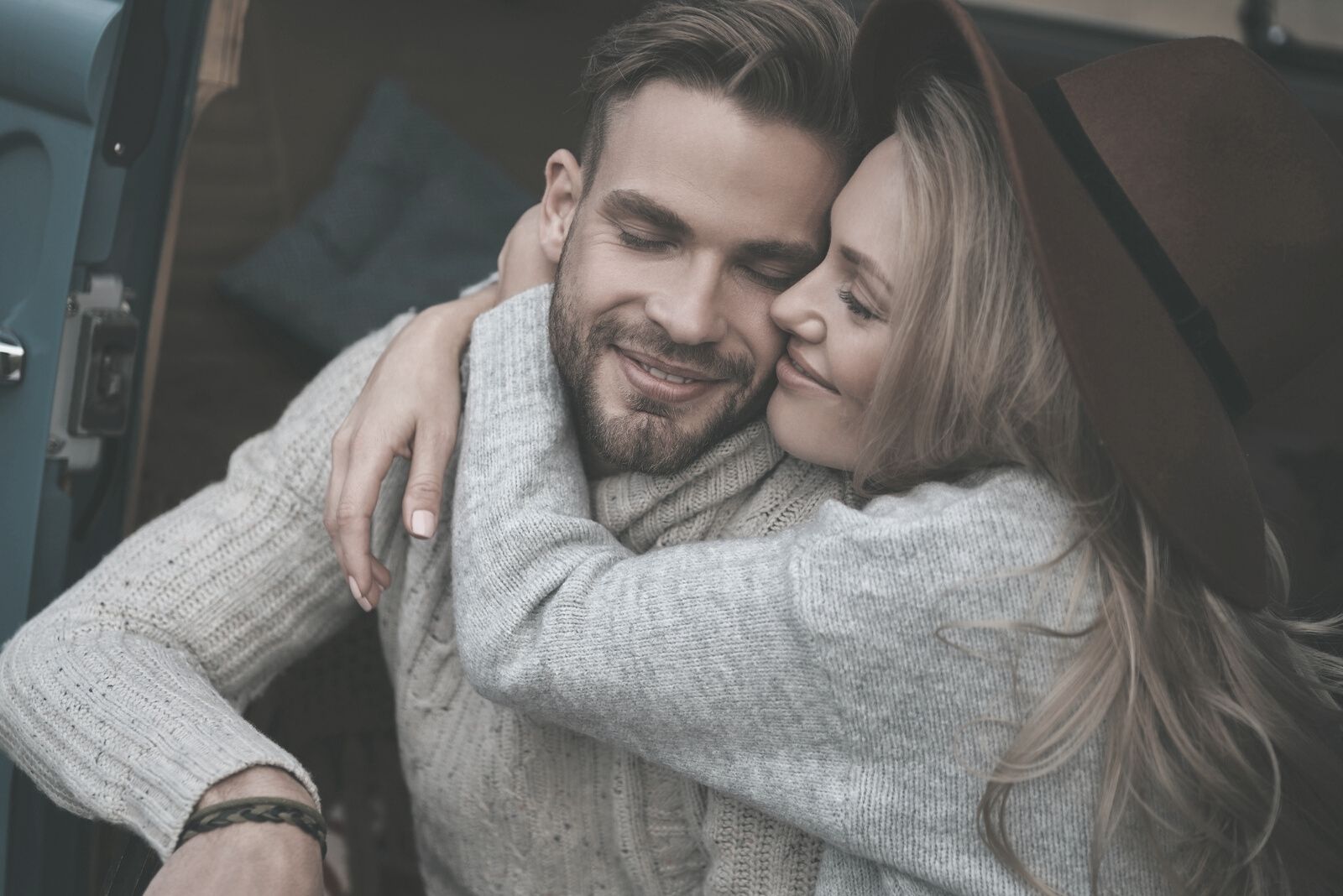 happy woman embracing his man while both closing eyes full of love