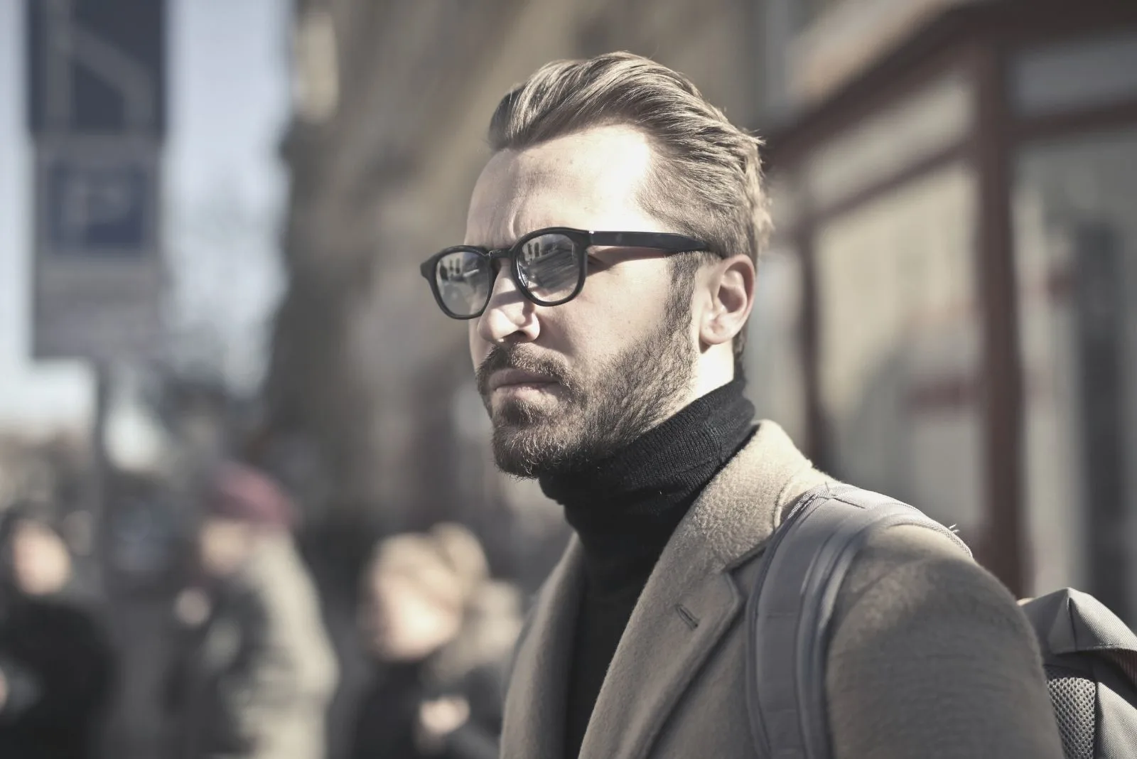 man wearing eyeglasses with suit in fashion standing outdoors