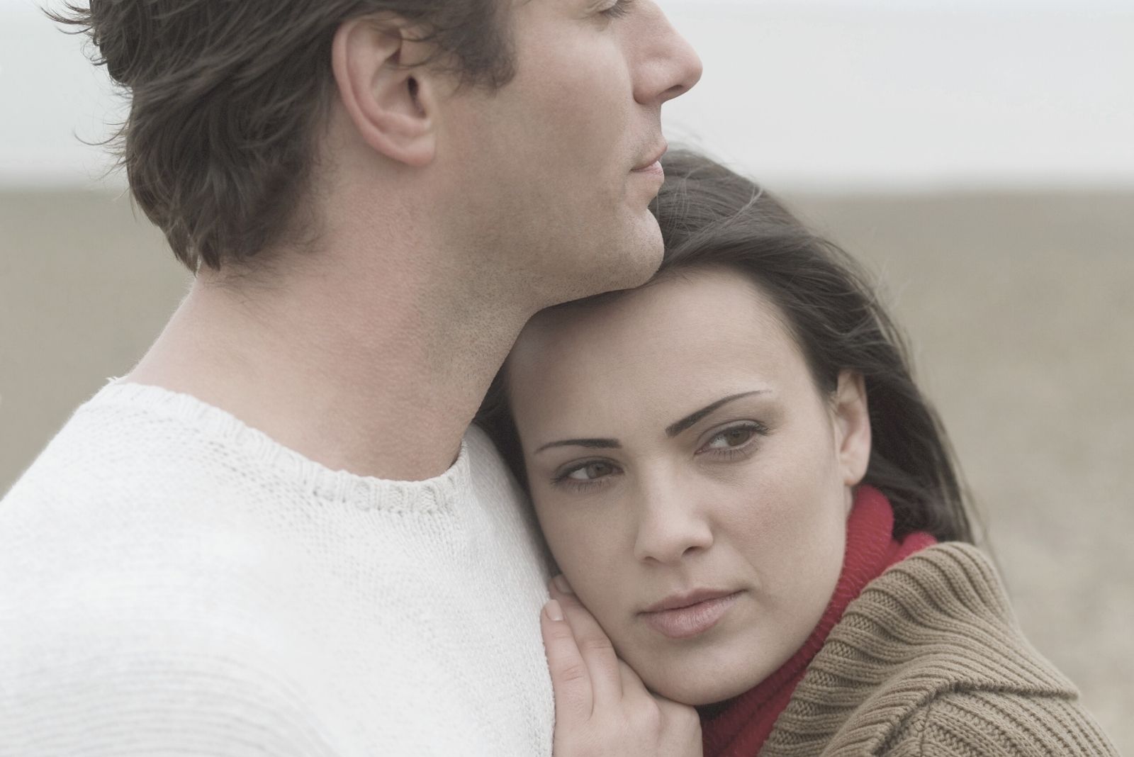 pensive woman hugging and leaning on the handsome man