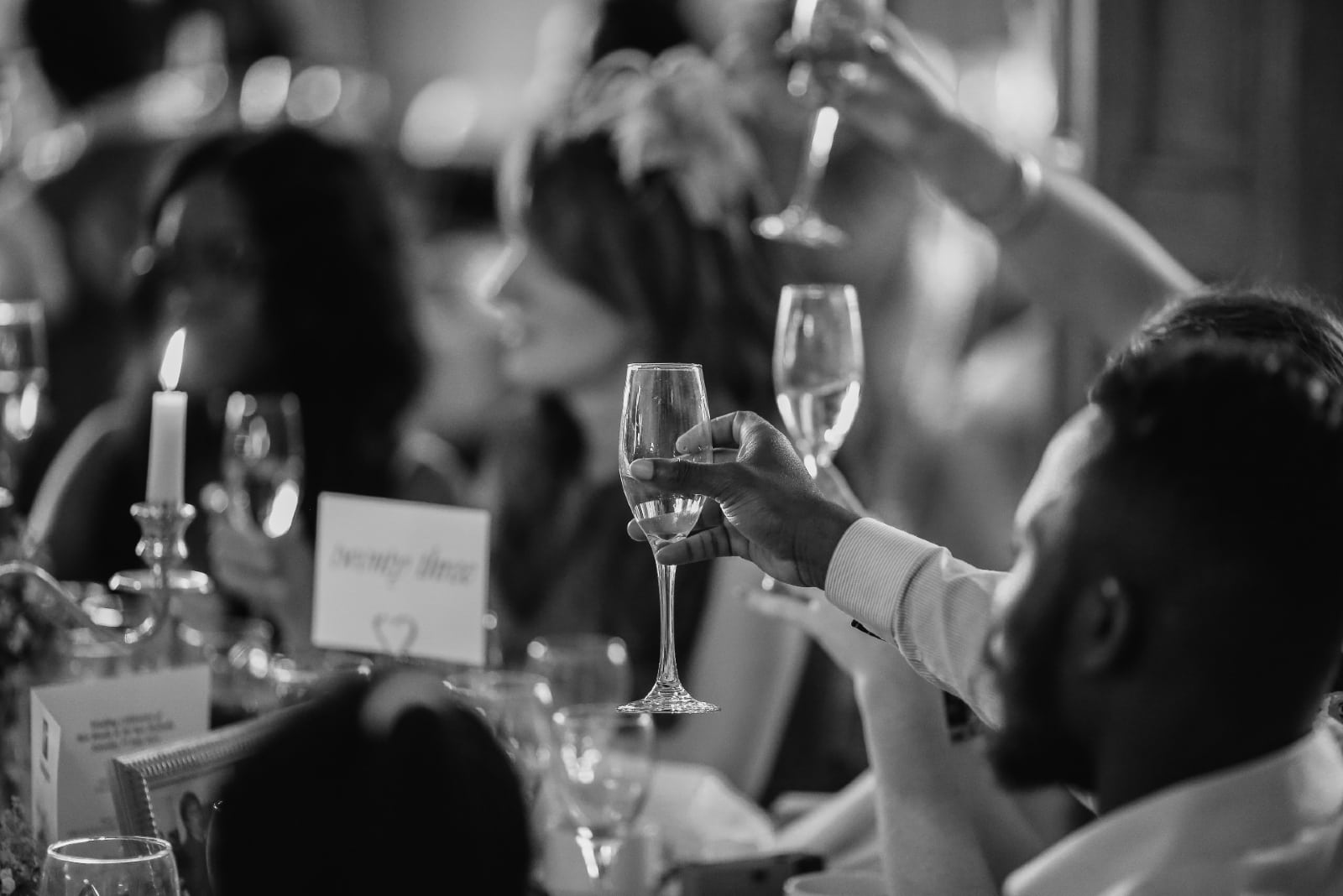 people toasting with champagne while sitting at table