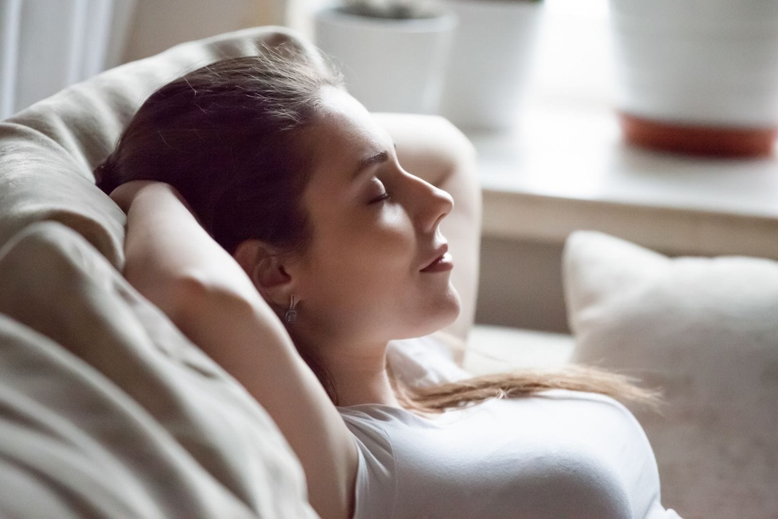 relax calm woman smiling and resting on the couch in sideview in closeup photography