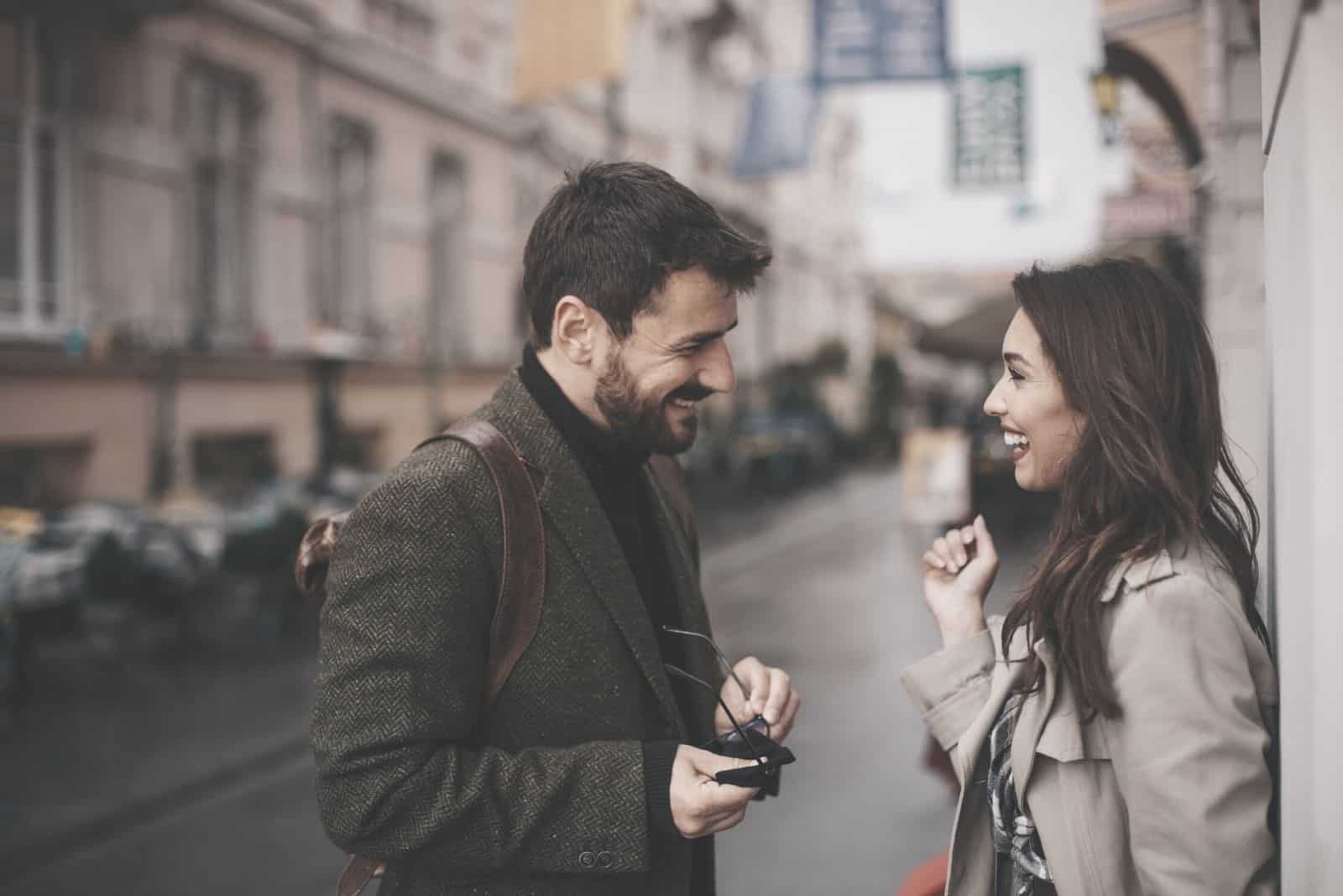 two young hipster having nice conversation on the street with an autumn weather