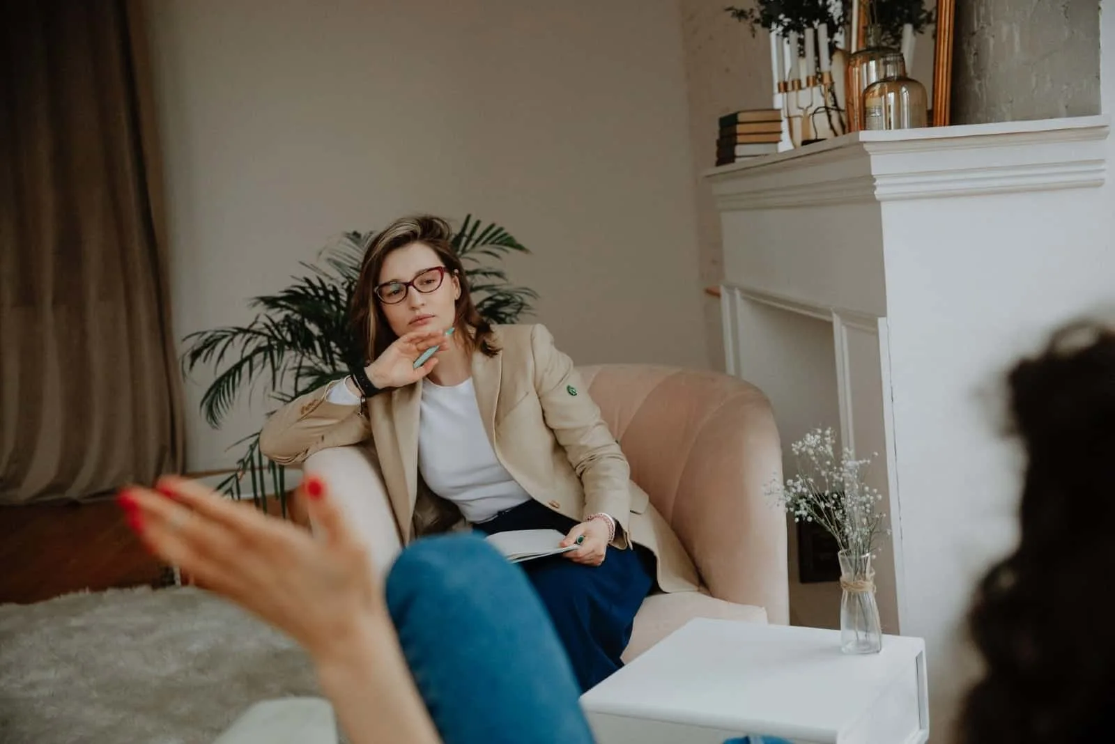 woman talking to therapist while sitting indoor