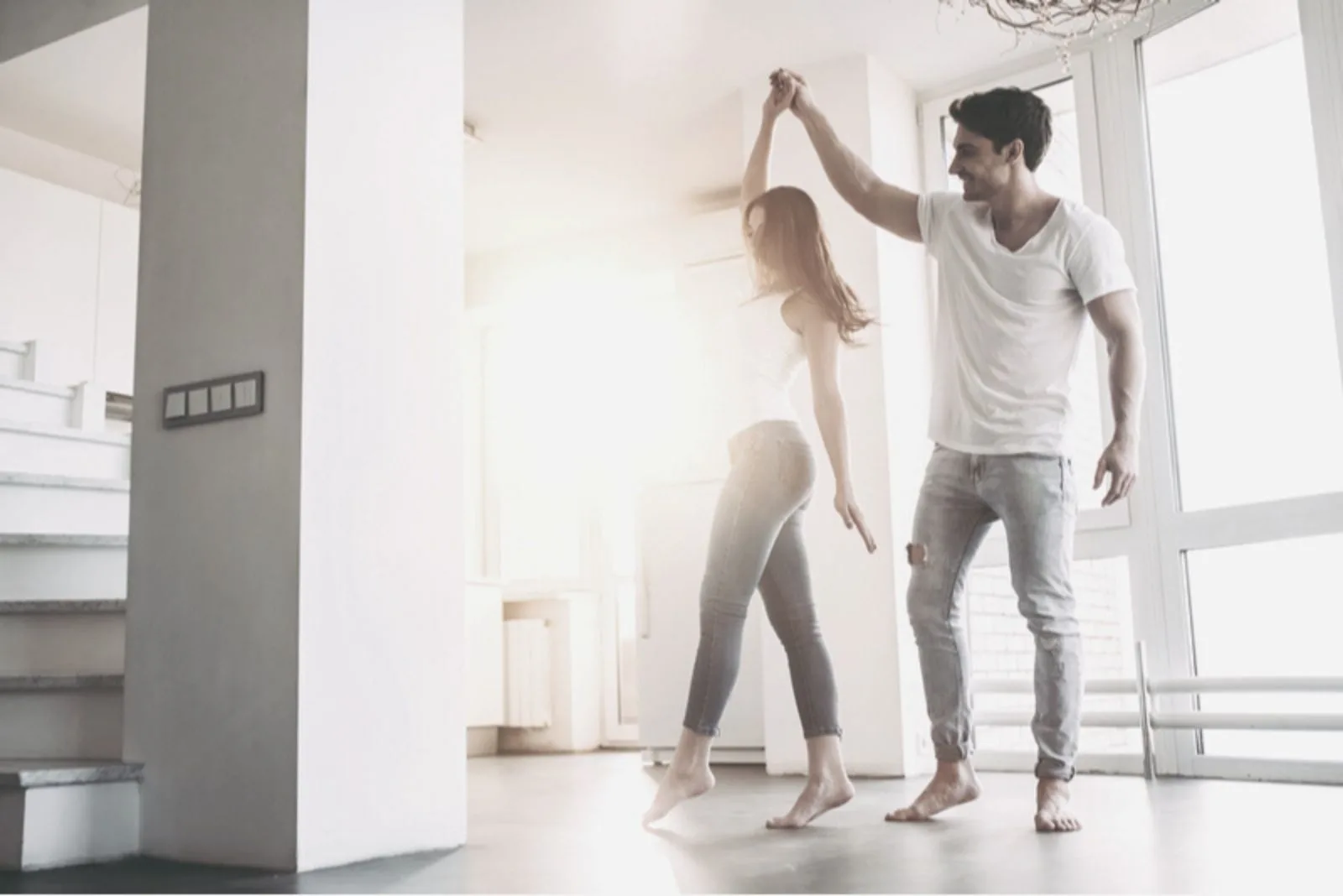 young couple dancing barefooted inside the dancing room
