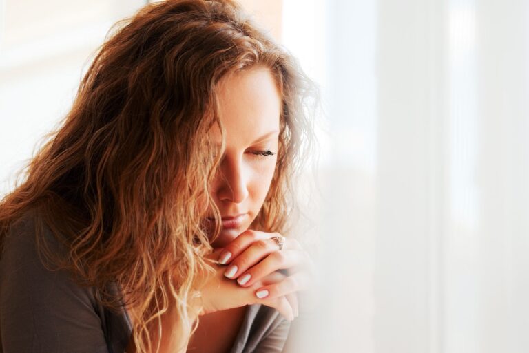 sad pensive woman sitting alone