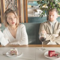 resentful woman talking to man while having a date at the restaurant in a horizontal shot