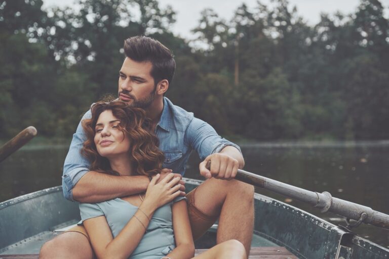 couple in love riding a boat in the river
