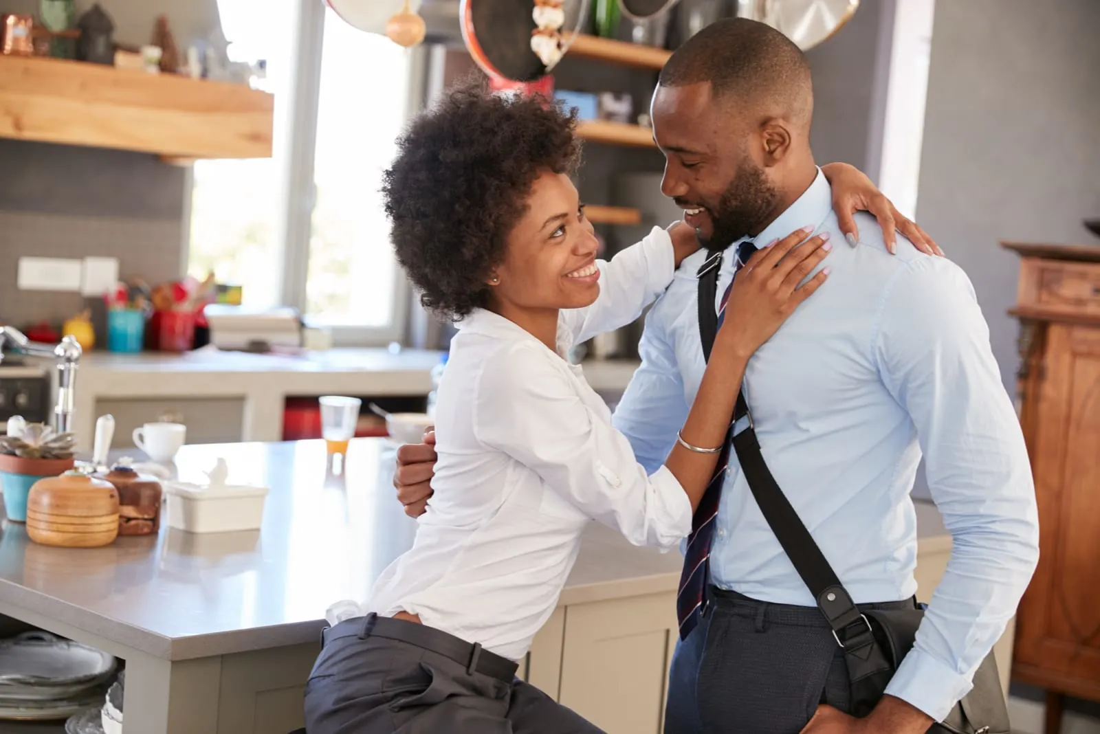 a happy loving couple hugging in the kitchen