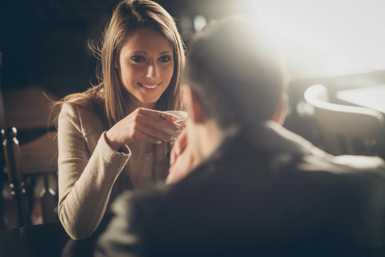 a man and a woman talking over coffee
