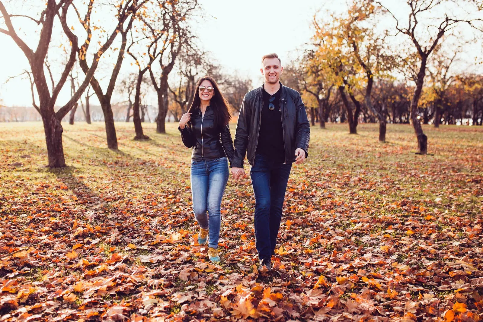 a man and a woman walk and hold hands
