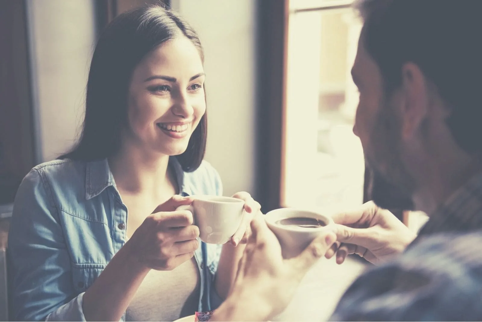 couple chit chatting and drinking coffee inside the cafe