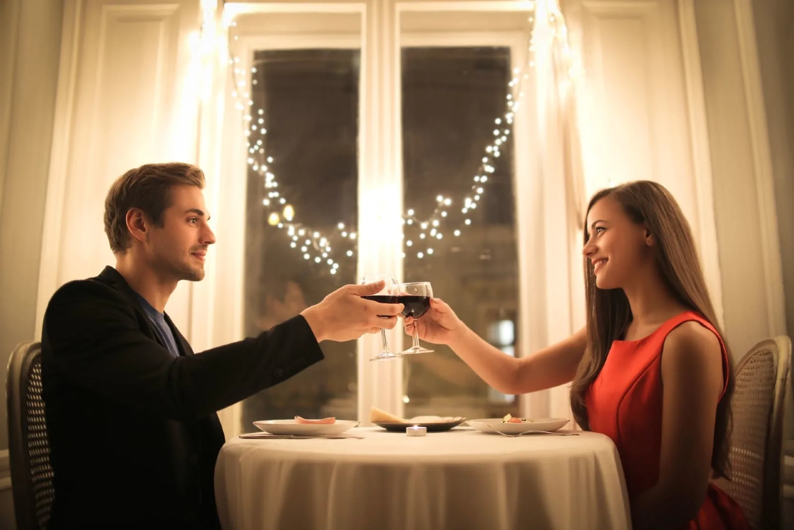 man and woman having romantic dinner at home