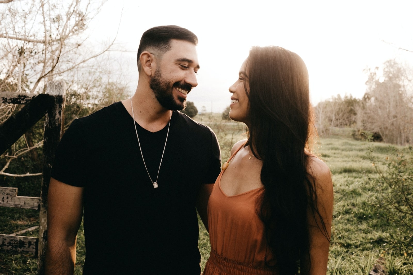 man and woman making eye contact while standing in the field