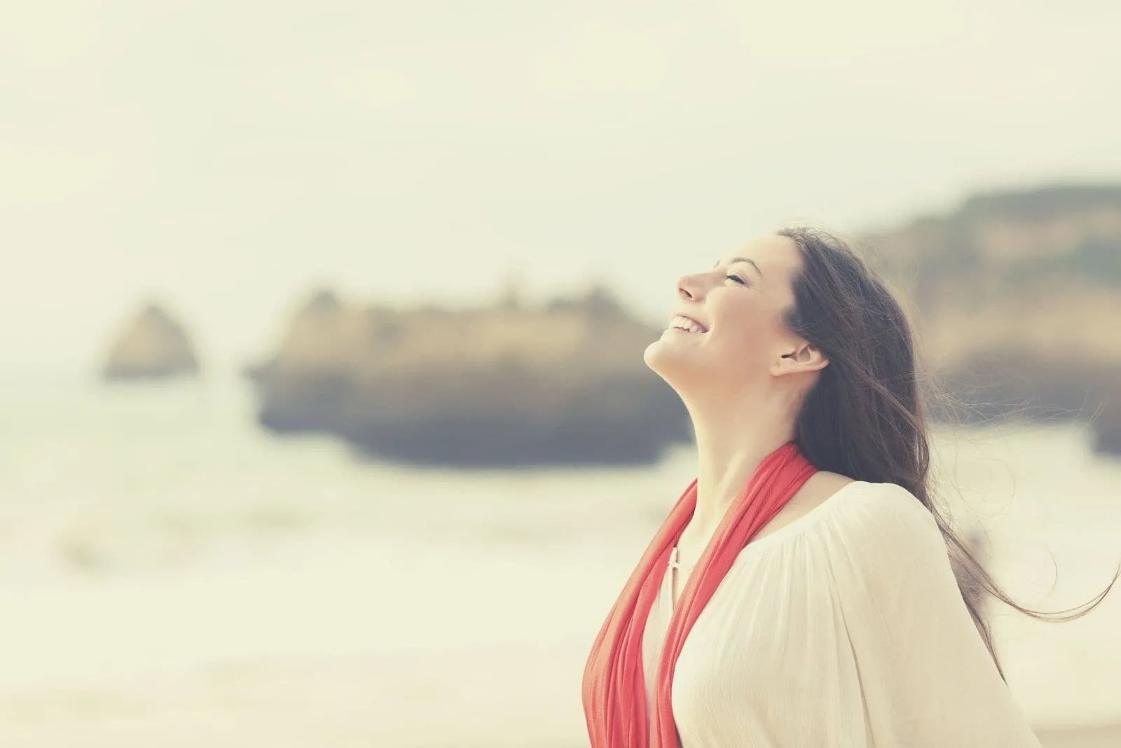 happy woman breathing deeply standing on the beach