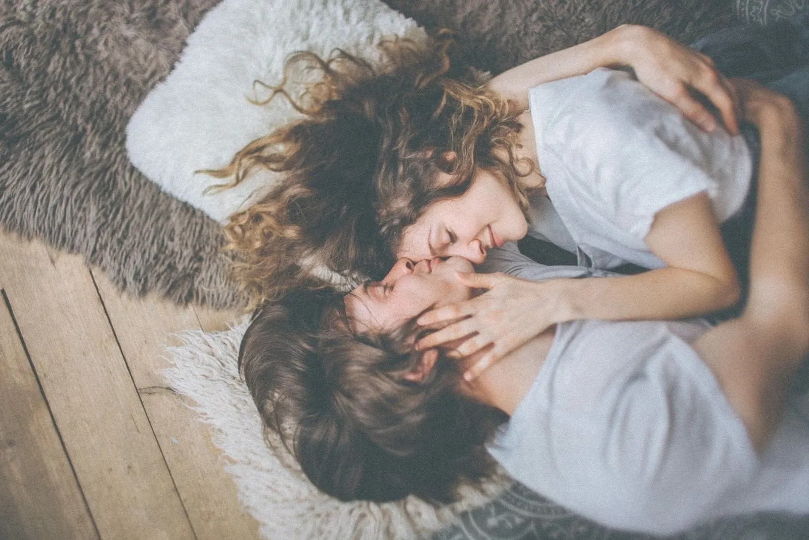 image of a couple in love lying down on the floor on a floormat