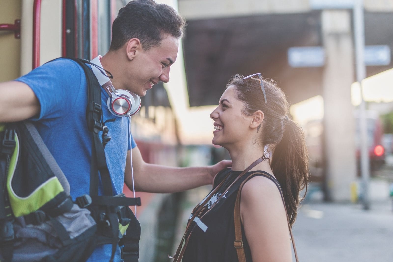 image of a guy arriving and meeting his long distance girlfriend stepping down the train or bus