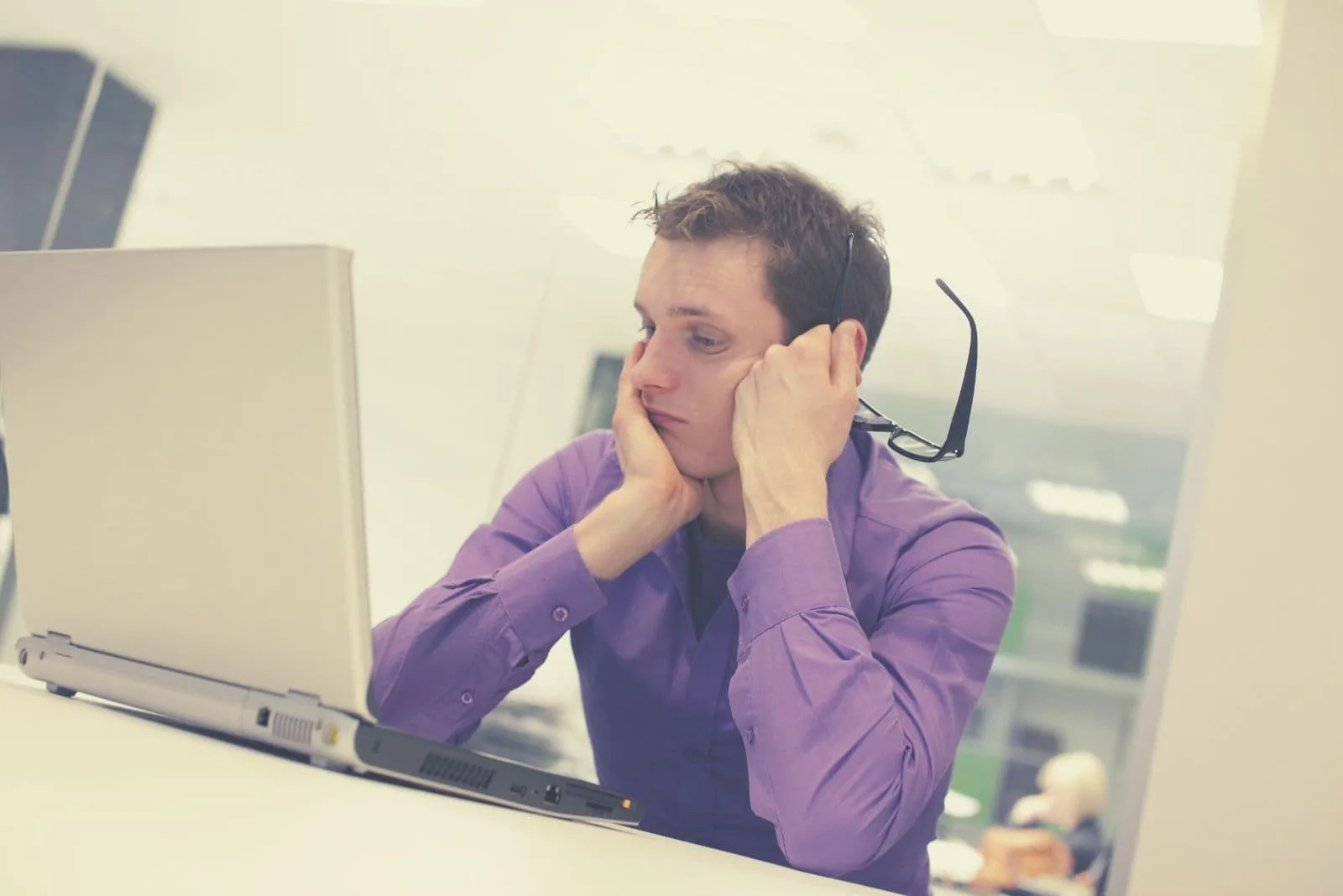 man having problems inside the office staring at his computer